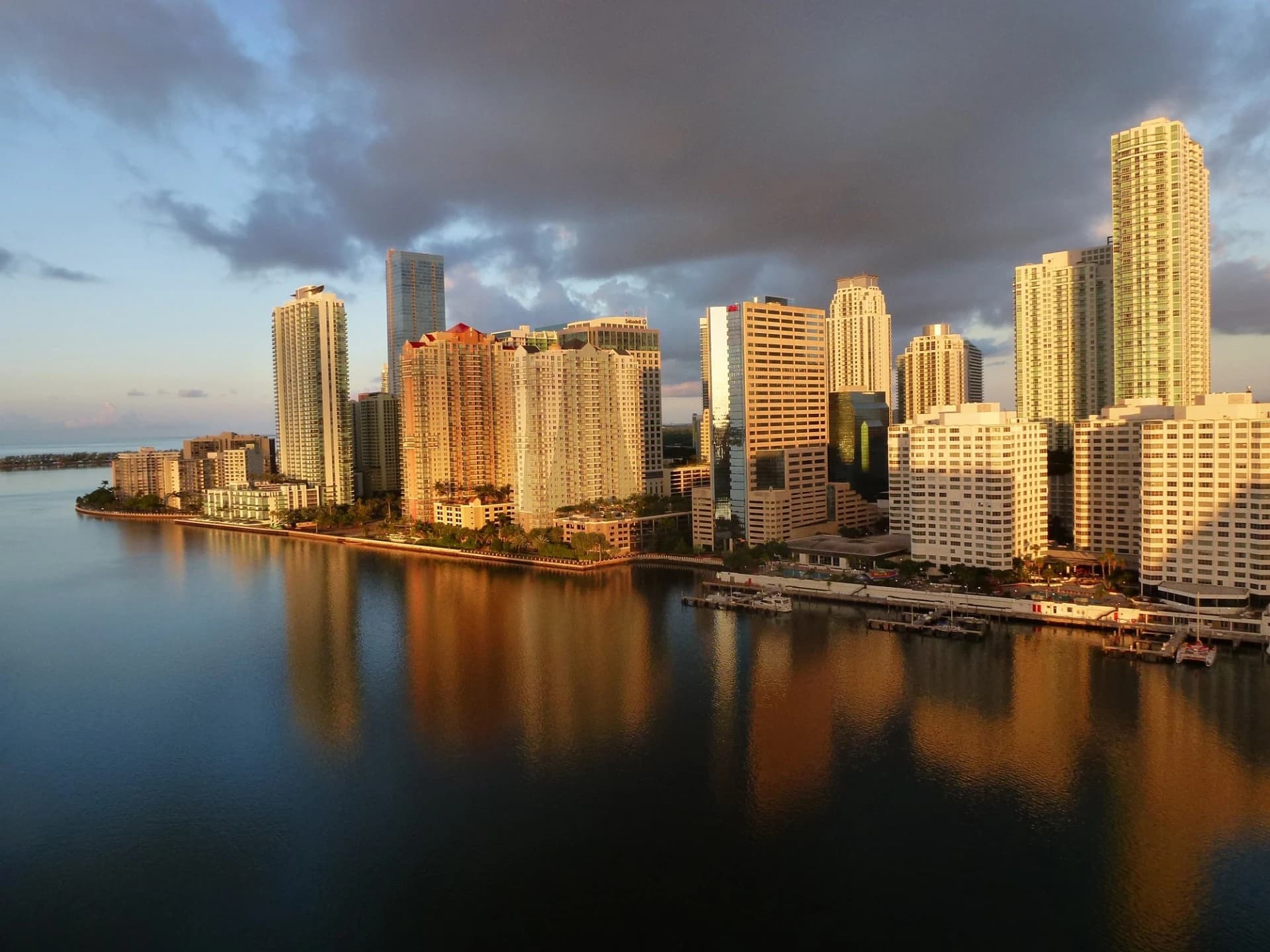 Miami waterfront skyline with warm evening light reflected across Biscayne Bay